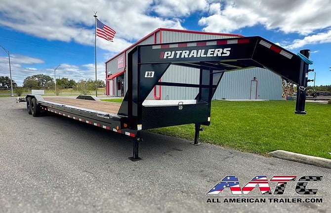 A versatile PJ 36-foot gooseneck car hauler trailer with a 15,680 GVWR, model B8-362. This PJ Trailer is designed for multi-car hauling and offers the convenience of slide-in ramps and large tires. With electric brakes, a black finish, and a gooseneck tongue type, it's a reliable choice for hauling multiple vehicles. The trailer measures 36x8.5 feet, making it ideal for transporting a variety of vehicles and equipment.