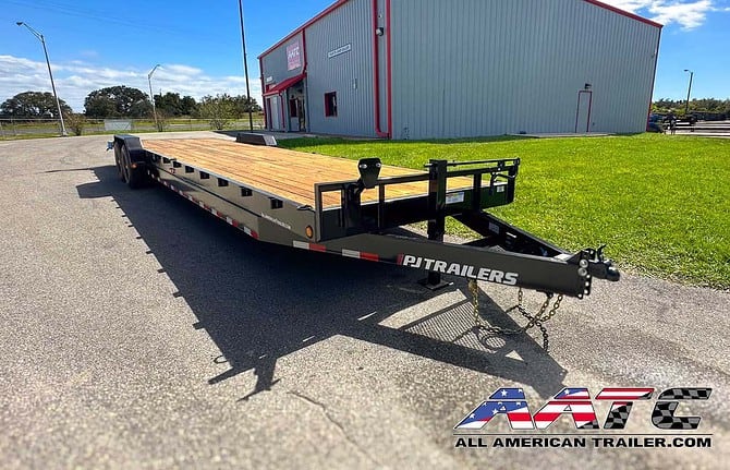 A versatile PJ 34-foot bumper pull car hauler trailer, model C8-342, designed for transporting two cars, or a bobcat and more. This PJ Trailer features slide-in ramps, large tires, and a 14,000 GVWR, making it suitable for multi-car hauling. With electric brakes, a black finish, and a load capacity of 9185 lbs, it's a robust choice for various hauling needs. The bumper pull design provides convenient towing.
