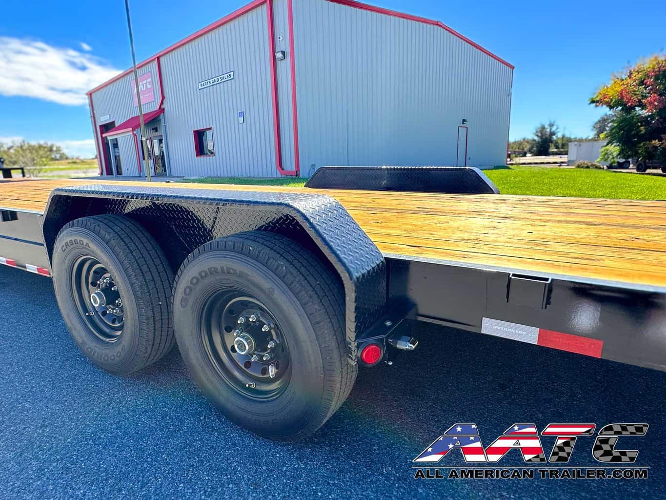 A versatile PJ 34-foot bumper pull car hauler trailer, model C8-342, designed for transporting two cars, or a bobcat and more. This PJ Trailer features slide-in ramps, large tires, and a 14,000 GVWR, making it suitable for multi-car hauling. With electric brakes, a black finish, and a load capacity of 9185 lbs, it's a robust choice for various hauling needs. The bumper pull design provides convenient towing.