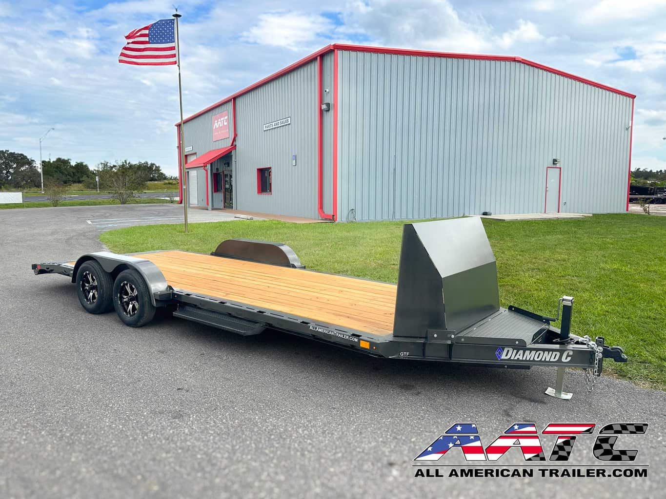 A versatile and durable 20-foot single car hauler from Diamond C, model GTF-18+2. This Diamond C Trailer is designed for open car hauling, with a 7,000 GVWR and 18+2 configuration featuring a steel rock shield and convenient slide-in ramps. The car hauler is 20x7 feet, equipped with electric brakes, a bumper pull design, and a metallic gray finish. It also comes with a 7,000 lb drop-leg jack, LED lights, and an adjustable coupler for added functionality and convenience.