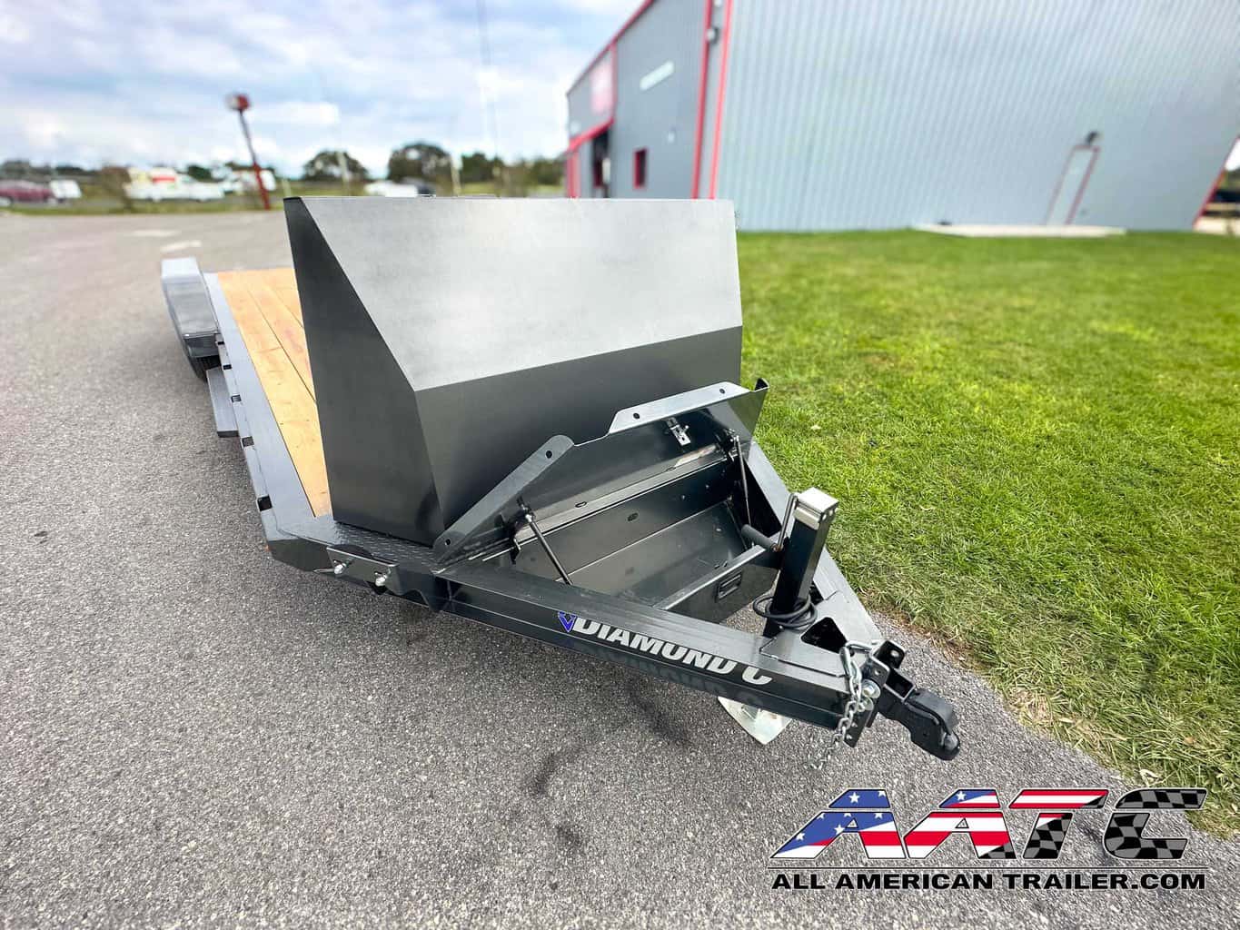 A versatile and durable 20-foot single car hauler from Diamond C, model GTF-18+2. This Diamond C Trailer is designed for open car hauling, with a 7,000 GVWR and 18+2 configuration featuring a steel rock shield and convenient slide-in ramps. The car hauler is 20x7 feet, equipped with electric brakes, a bumper pull design, and a metallic gray finish. It also comes with a 7,000 lb drop-leg jack, LED lights, and an adjustable coupler for added functionality and convenience.